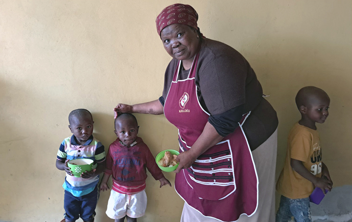 Nokwanda Keleku, co-founder of Masakhane Soup Kitchen, feeds community children in Philippi, a township community in Cape Town, South Africa. Photo by Alvin Makunike, UM News.