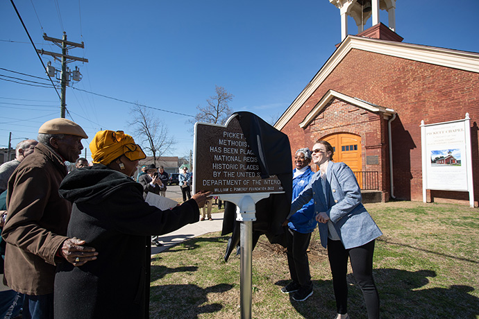 Ashley Boggan (right) and Linda Tapley unveil a marker recognizing Pickett Chapel’s status on the National Register of Historic Places. Tapley attended the church as a child. At left are Harry and Mary Harris of the Wilson County Black History Committee. Photo by Mike DuBose, UM News.