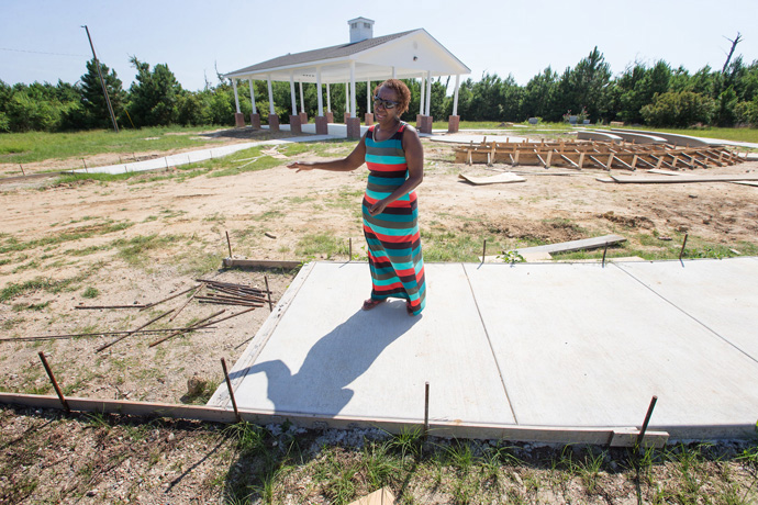 Dorothy Booker walks along the incomplete outdoor prayer pavilion at Gulfside Assembly in Waveland, Miss., in 2015. Hurricane Katrina destroyed all of the buildings in 2005. File photo by Mike DuBose, UM News.