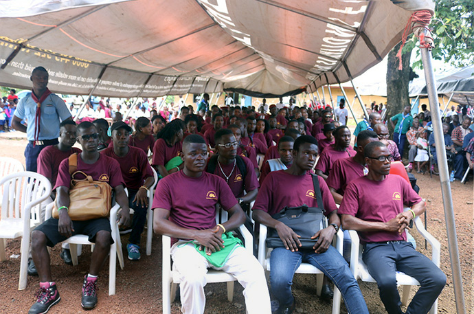 Students sit at the dedication ceremony of Taiama Enterprise Academy, a hybrid vocational, science and entrepreneurship training school launched by The United Methodist Church in Sierra Leone. Opened four years ago, the school struggled to roll out some programs because it lacked a reliable power source to provide upscale training. Now, the school has 24/7 solar-powered electricity. Photo by Phileas Jusu, UM News.