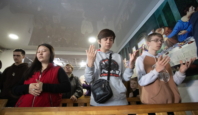 Young people pray during worship at Livespring United Methodist Church in Kara-Balta, Kyrgyzstan. The church's pastor says at least half of the members are young people. Photo by Mike DuBose, UM News.