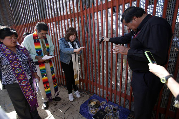 This file photo shows Methodist church leaders in the U.S. and Mexico. From left to right are: María Calixlo-Luna, Methodist Church of Mexico Bishop Felipe Ruiz Aguilar, United Methodist Bishop Minerva Carcaño and Guillermo Navarrete, lay leader from the Methodist Church of Mexico who leads the border ministry. They were praying in Parque El Faro (Mexican side), as part of the ecclesiastical activities that this border ministry develops with neighboring communities and immigrant families on both sides of the border. File photo by Kathleen Barry, UM News.