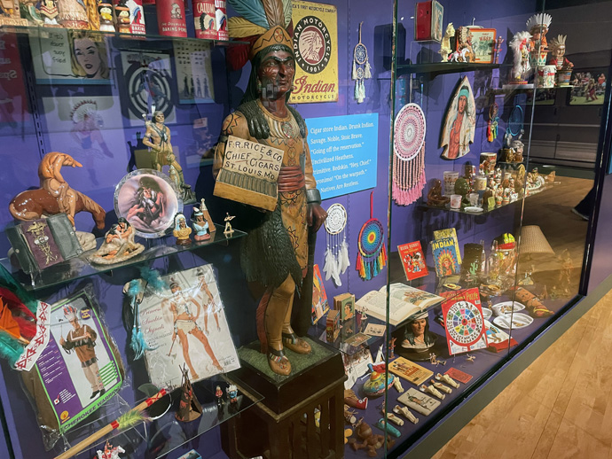 A cigar store Indian statue is displayed amongst other stereotypical representations of Native Americans at the First Americans Museum in Oklahoma City on March 9, 2023. Photo by Jim Patterson, UM News.