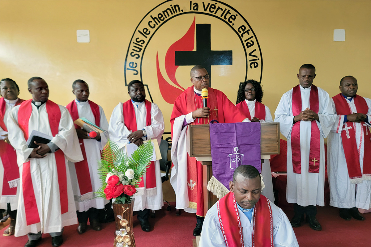United Methodist Bishop Daniel Lunge introduces the Rev. Christian Ntondele after praying for him. Ntondele, a graduate of the Protestant University of Central Africa in Cameroon, will supervise the new United Methodist church in Brazzaville. Photo by the Rev. Fiston Okito, UM News.