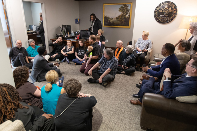 Clergy members take a seat on the floor at the office of Cameron Sexton, speaker of the Tennessee House of Representatives, after being told that Sexton was in an all-day meeting and did not have time to hear their pleas for gun reform. Photo by Mike DuBose, UM News.