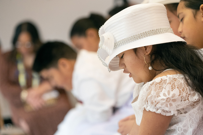 Baby Lula Lavata'i prays during the chartering service for Ola Toe Fuataina United Methodist Church in Anchorage, Alaska. Photo by Mike DuBose, UM News.