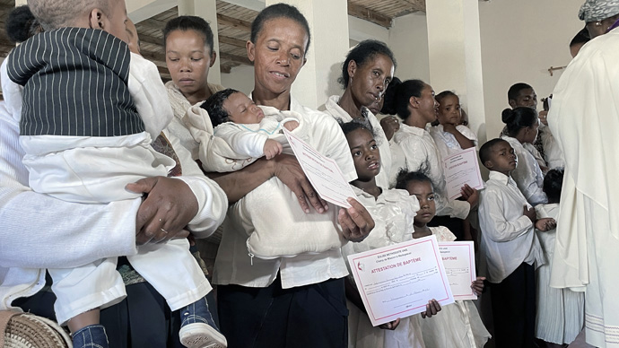 Participants receive their baptism and confirmation certificates during the inaugural service of Ambodifasika United Methodist Church in Antananarivo, Madagascar. Nearly 200 people of all ages were baptized and confirmed during the Feb. 27 service. Photo by the Rev. Gustavo Vasquez, UM News.