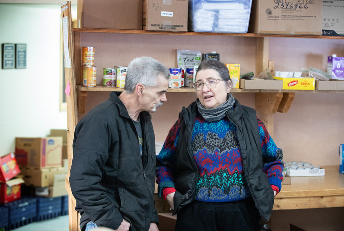 Jimmie Hutson visits with the Rev. Christina DowlingSoka at the Willow (Alaska) Community Food Pantry. DowlingSoka is the co-pastor of Willow United Methodist Church, which hosts the food pantry. She also serves as superintendent of the Alaska Conference. Photo by Mike DuBose, UM News. 