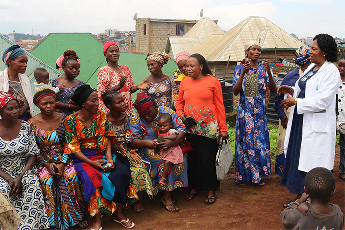 Women and children gather outside United Methodist Irambo Health Center in Bukavu, Congo, to hear from Dr. Marie Claire Manafundu (right), who coordinates the church’s Maternal and Child Health Program in eastern Congo. With funding from the United Methodist Board of Global Ministries, the church supports a program for more than 100 women living with HIV in the Kivu Conference. Photo by Philippe Kituka Lolonga, UM News.