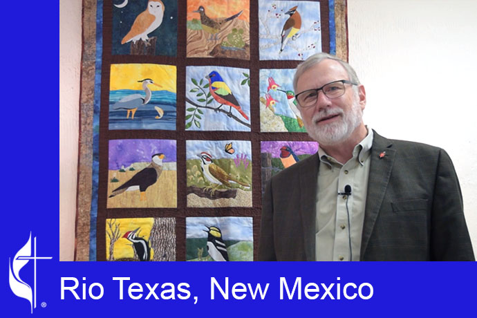 Bishop Robert Schnase stands in front of a colorful quilt of birds made by his wife, Esther Schnase. Video image courtesy of the Rio Texas and New Mexico Conferences via Vimeo by UM News.