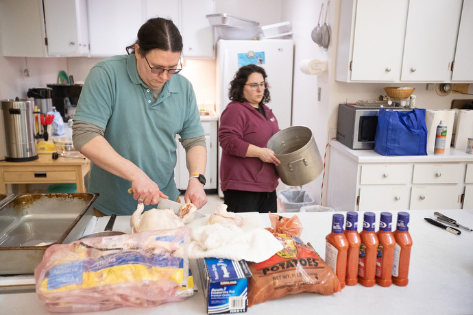 The Rev. Murray Crookes and his wife, Deaconess Maria Capezio Crookes, prepare dinner for guests of the weekly fellowship meal and Bible study at Every Nation United Methodist Church. Photo by Mike DuBose, UM News.