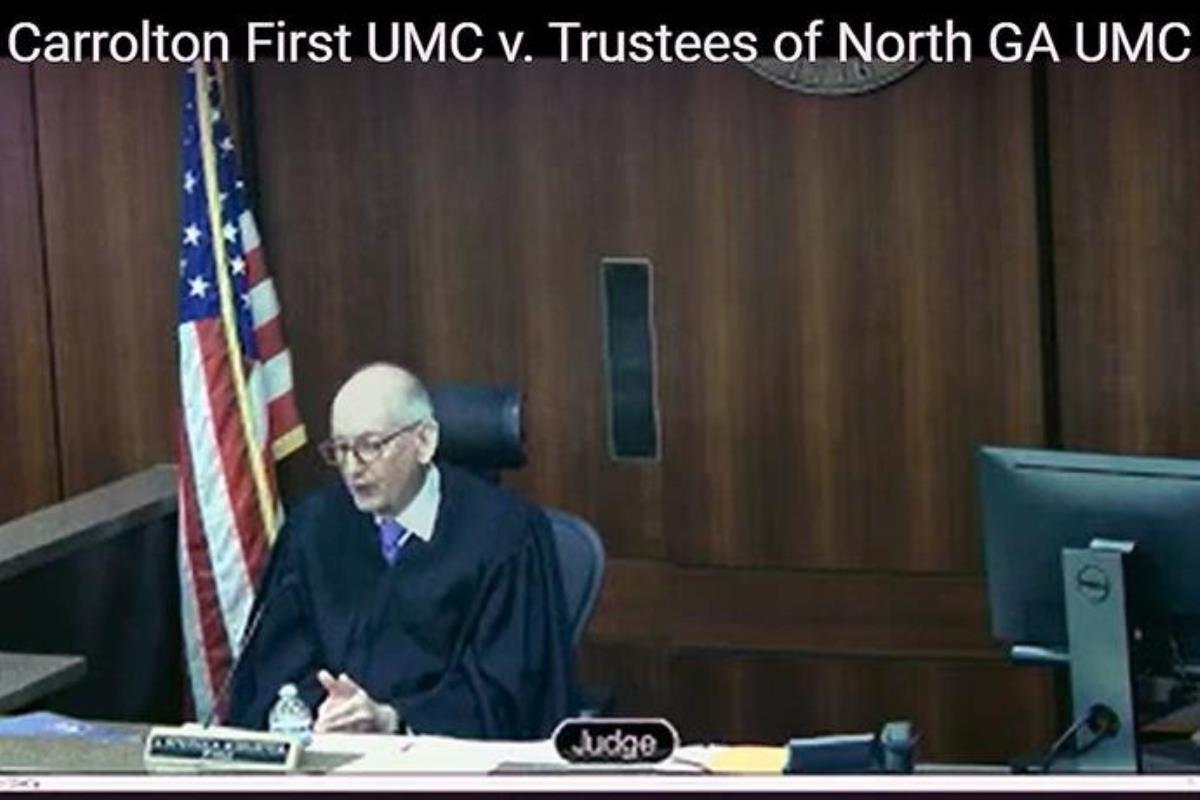 Cobb County Superior Court Judge J. Stephen Schuster, at the end of a daylong hearing, rules from the bench that more than 180 churches in the North Georgia Conference can proceed with The United Methodist Church’s disaffiliation process. The conference had paused disaffiliation votes in the wake of what it called defamatory misinformation. Screengrab courtesy of Cobb County Superior Court via YouTube by UM News.