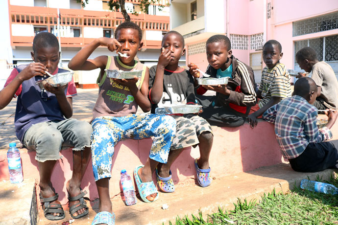 Os meninos saciam a fome e a sede depois de receberem uma refeição decente providenciada pela Metodista Unida Central de Malanje, Angola. Foto de João Goncalves Nhanga.