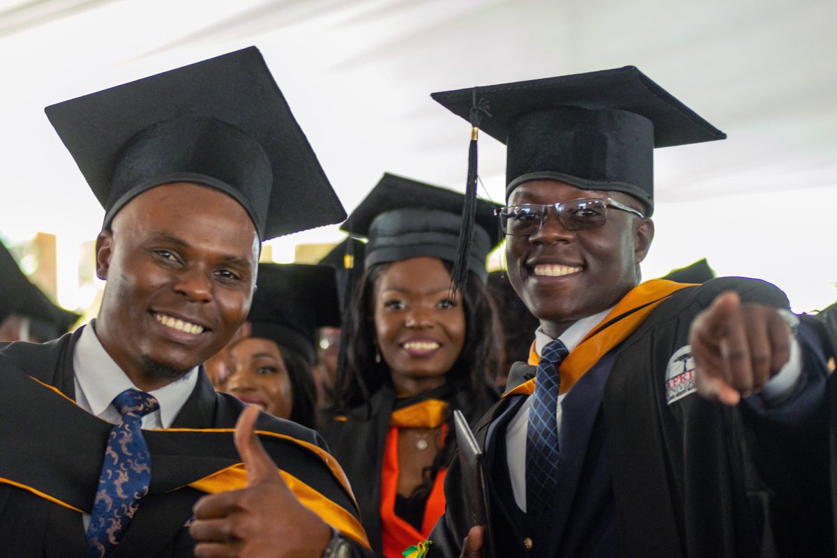 Graduados sorriam na 29ª cerimônia de formatura na África University em 10 de Junho em Mutare, Zimbábue. A escola da Metodista Unida graduou sua maior turma com mais de 950 alunos de 19 países. Foto de Arty Events para a África University.