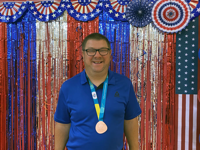 James Thigpen wears his bronze medal during Wesley Glen Ministries’ Fourth of July party held after his return from the Special Olympics World Games in Berlin. Photo courtesy of Wesley Glen Ministries.