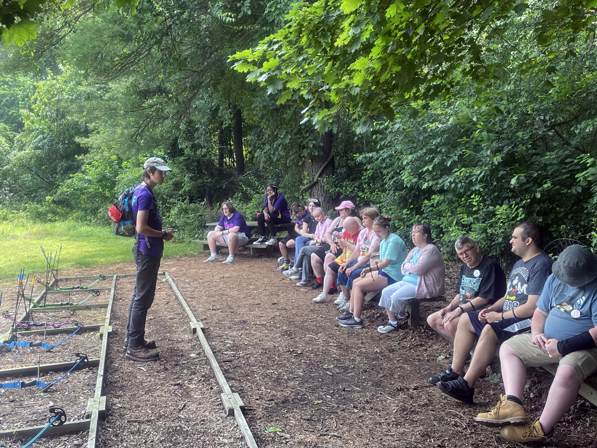 Jordan Wagaman (left) instructs challenge campers June 29, before they try their hand at archery at Innabah Camp and Retreat Center in Spring City, Pa. The campers are taking part in a week-long camp for adults with developmental disabilities. Photo by Jim Patterson, UM News.
