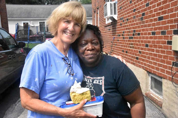 Volunteer Marcia Etu (left) embraces Brenda Wyatt (right) on June 30, 2023, outside of Wyatt’s home, which was being repaired after damage from Hurricane Ida in 2021. Project Restoration has already helped 20 homeowners fix their houses in the Philadelphia area, and some 40 more are planned. Photo by John Coleman, Eastern Pennsylvania Conference.