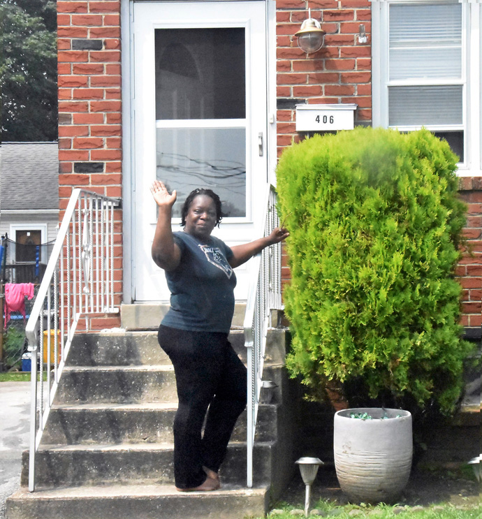 Brenda Wyatt waves goodbye to workers who are helping to repair her Collingdale, Pennsylvania, home. Photo by John Coleman, Eastern Pennsylvania Conference.