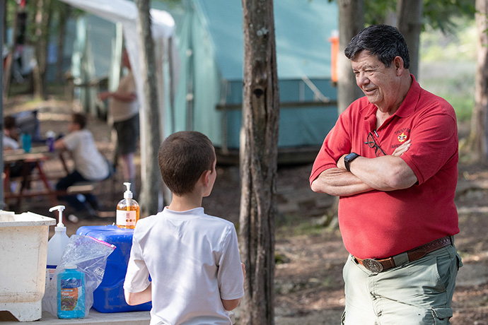 Scoutmaster Mike Warren offers some advice to Kyler Martell during summer camp at the Boxwell Scout Reservation. Photo by Mike DuBose, UM News