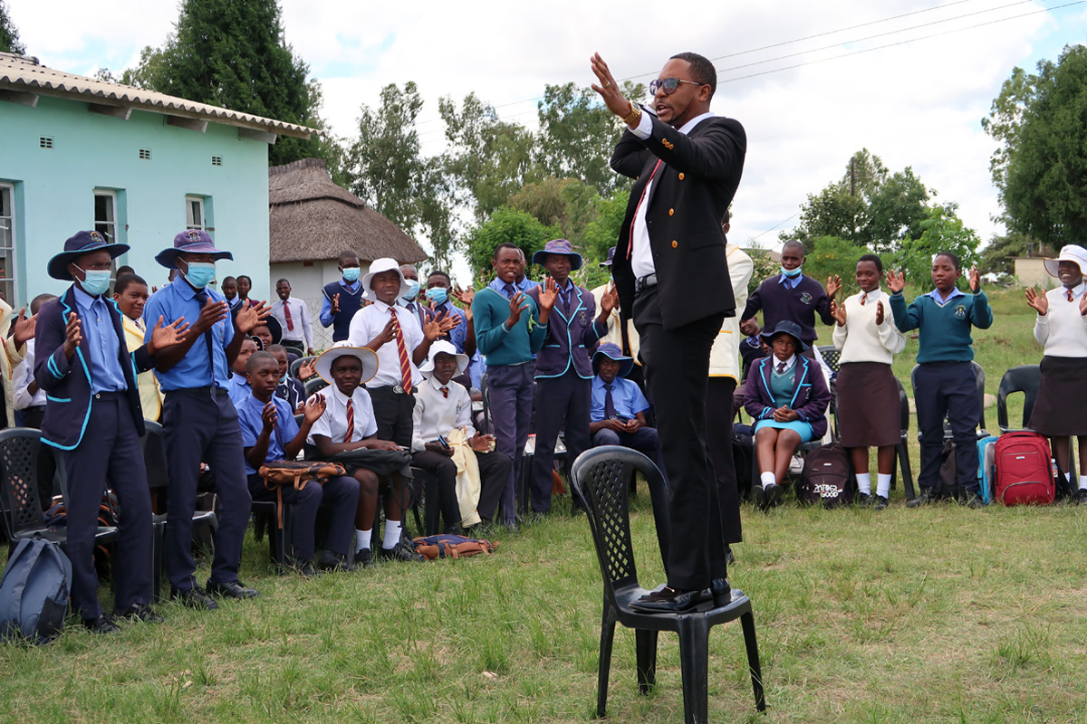 Elijah Chakwizira of Student Connect Trust conducts an ice-breaking exercise with students from Murape and Seke Materera secondary schools in Seke, Zimbabwe. The organization conducts leadership and life-skills training, career development and team building. Photo by Eveline Chikwanah, UM News. 