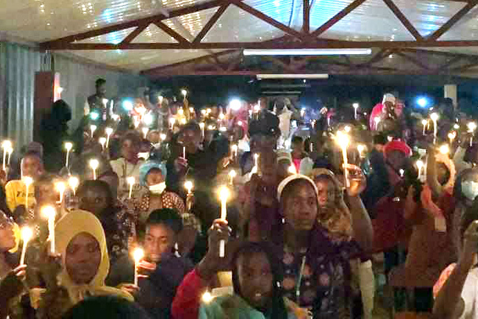 West Angola youth hold 71 candles to mark the 71st anniversary of the West Angola Conference’s Juventude Metodista youth group. The night of candles was one of the highlights of a six-day camp for youth ages 12-25 from the 12 districts of the conference. Photo courtesy of Juventude Metodista.