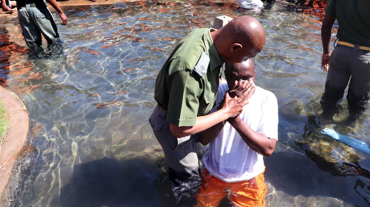 Chaplain Jefat Zhou baptizes one of 350 inmates christened at Chikurubi Maximum Security Prison in Harare, Zimbabwe, on July 28. The baptisms were part of a United Methodist prison ministry led by of the Harare East District’s Church and Society Committee. Photo by Prudence Choto, Chikurubi Maximum Security Prison.