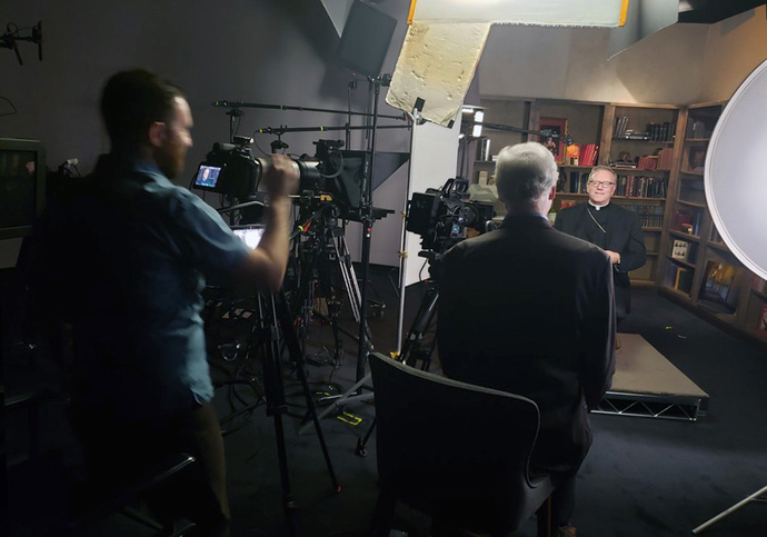 Filmmaker Martin Doblmeier interviews Catholic Bishop Robert Barron, who serves as bishop of the Diocese of Winona-Rochester in Southern Minnesota, for “Sabbath: An Ancient Tradition Meets the Modern World.” Deryl Davis, a producer for the film, is United Methodist. Photo courtesy of Journey Films.