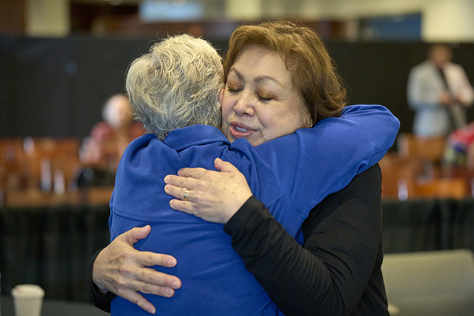United Methodist Bishop Minerva G. Carcaño gets a hug from the Rev. Mary Maaga following the announcement of the jury verdict on Sept. 22, the fourth day of Carcaño's church trial in Glenview, Ill. The bishop was found not guilty on all four charges against her. Maaga, a pastor in the California-Nevada Conference, was a witness for Carcaño during the trial. Photo by Paul Jeffrey, UM News.