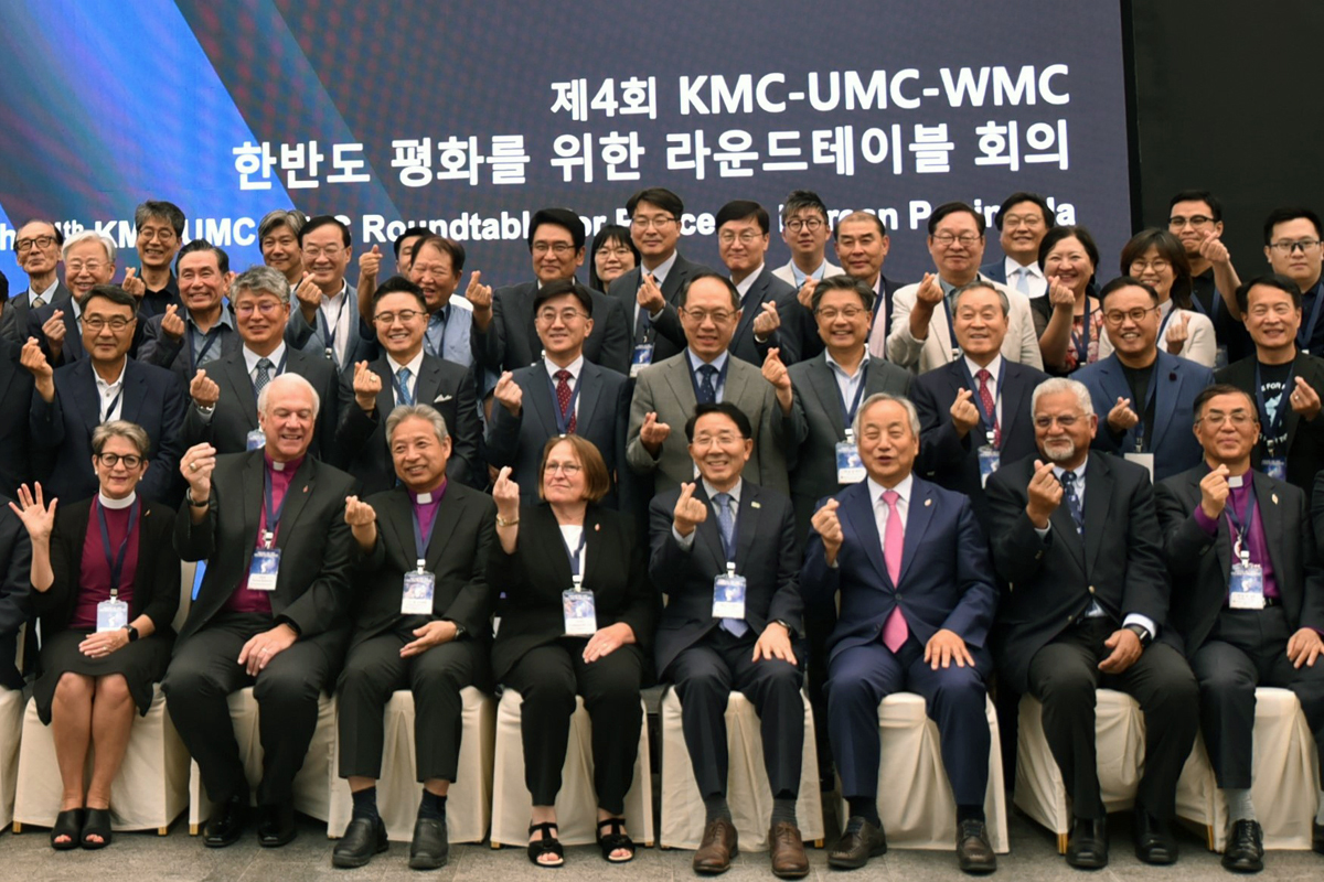 Participants of the Fourth Roundtable for Peace on the Korean Peninsula make a sign of love with their fingers. The event, hosted by the Korean Methodist Church, The United Methodist Church and the World Methodist Council, was held Aug. 28-29 at the Ambassador Hotel and Kwanglim Methodist Church in Seoul, South Korea. Photo by the Rev. Thomas E. Kim, UM News.