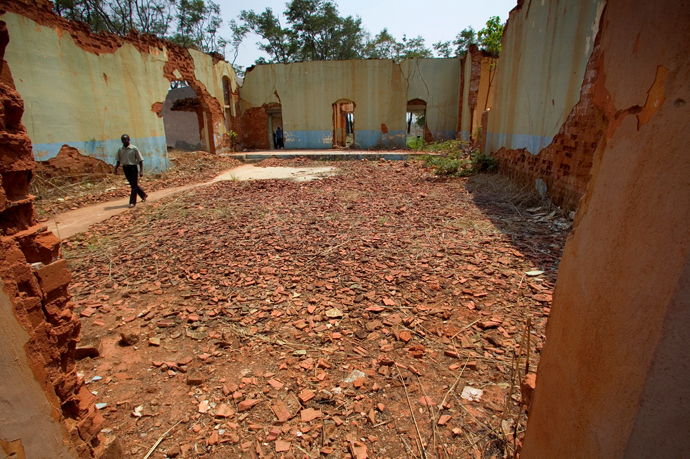 The Rev. Simao Antonio, pastor of Eva de Andrade United Methodist Church in Malanje, Angola, walks through the ruins of his former elementary school, the school of "Love and Happiness," at the Quéssua Methodist Center. Quéssua was bombed out of existence at the beginning of the country's long civil war, in an act of revenge against the first president of Angola, who was a United Methodist. 2006 file photo by Mike DuBose, UM News. 