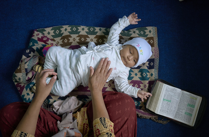 Five-month-old Yamimah plays on the floor as her mother, Chameli Rai, participates in an ecumenical seminar on women and leadership on May 23 at Hebron United Methodist Church in Lalitpur, Nepal. The workshop was co-sponsored by United Women in Faith. Photo by Paul Jeffrey, UM News.