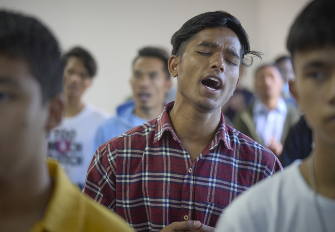 A man sings during worship at Hebron United Methodist Church on May 20 in Lalitpur, Nepal. While the congregation loses members who leave to find work elsewhere, it regains members when migrants return home after having attended Christian churches in other countries. Photo by Paul Jeffrey, UM News.