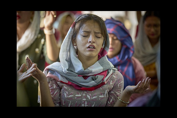 A woman prays during worship at Hebron United Methodist Church in Kathmandu, Nepal, on May 20. Christians comprise only about 1.4 percent of Nepal’s 30 million people. Over 80 percent of the population is Hindu. The remainder are mostly Buddhist and Muslim. Photo by Paul Jeffrey, UM News.