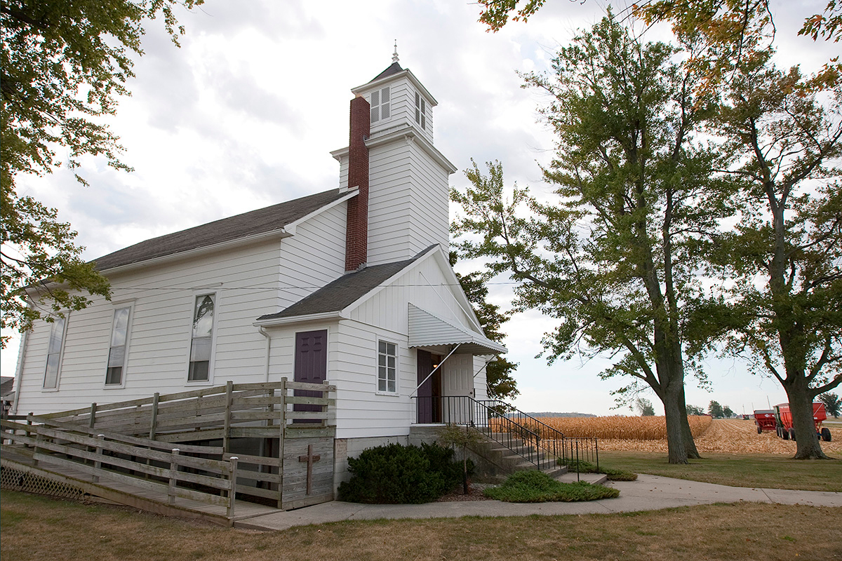 Corn is harvested from a field next to New Hope Bethel United Methodist Church outside Leipsic, Ohio, in 2010. Rural United Methodist churches are contributing to the economies of their communities up to $735,000 annually per congregation, according to a study funded by The Duke Endowment of rural congregations in North Carolina. File photo by Mike DuBose, UM News.