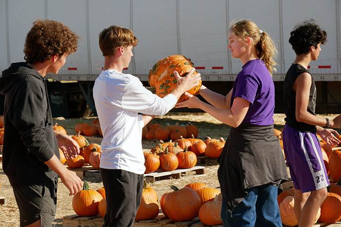 Passing pumpkins can be a good workout, as local students found out in helping with Grace Avenue United Methodist Church’s Pumpkins on the Prairie. Photo courtesy of Grace Avenue United Methodist Church.