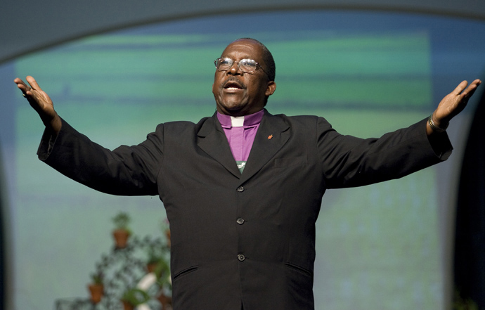 Bishop João Somane Machado of Mozambique (right) preaches at a morning worship service during the April 25 session of the 2008 United Methodist General Conference. Bishop Machado passed away on Oct. 25. File photo by Mike DuBose, UM News.  