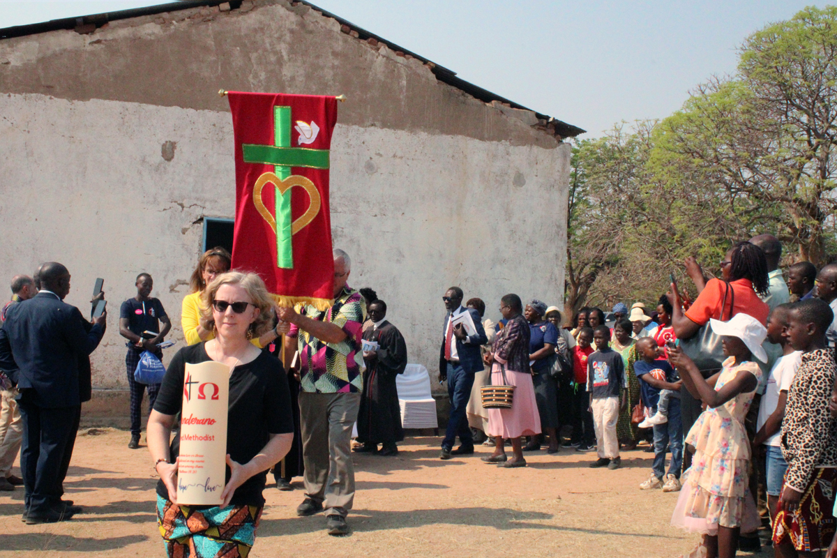 Members of Union United Methodist Church in Irmo, South Carolina, lead a procession from the old United Methodist Chitenderano Church sanctuary in Rusape, Zimbabwe, to a new sanctuary their church helped to build. Photo by Kudzai Chingwe, UM News.