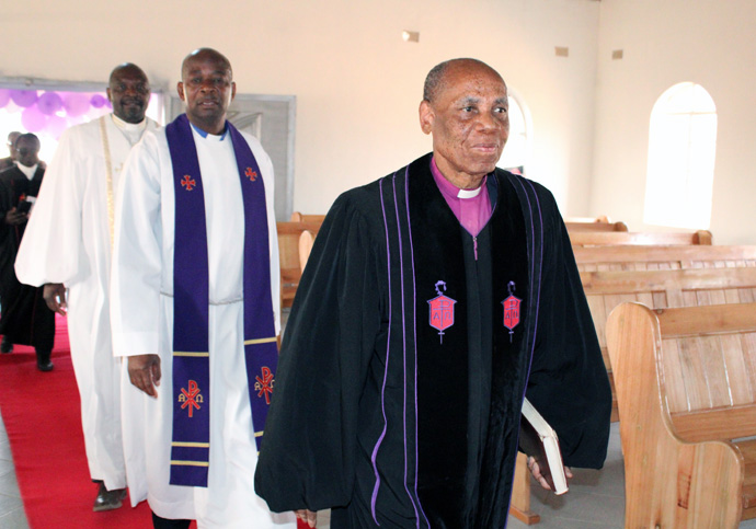 Zimbabwe Area Bishop Eben K. Nhiwatiwa (front), the Rev. Stephen Magomo, Makoni Buhera district superintendent, and the Rev. Lloyd Nyarota enter the new Chitenderano Circuit sanctuary in Rusape, Zimbabwe. Nyarota, a Chitenderano resident working in Canada, connected members of the circuit and Union United Methodist Church in Irmo, South Carolina, who helped raise money to construct the new church. Photo by Kudzai Chingwe, UM News.