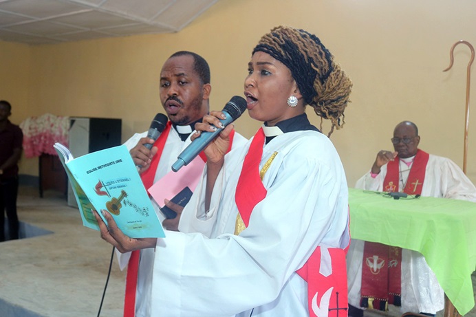 The Rev. Aquilas Soronaka and Deacon Cynthia Priscillia Soronaka sing “The Voice of the Lord Calls Me.” The couple’s ordination marked an historic moment for The United Methodist Church in the Central African Republic. Photo by Chadrack Tambwe Londe, UM News.