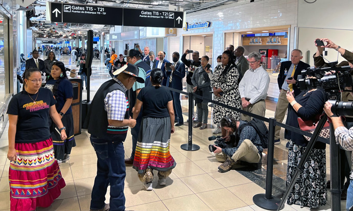 The Rev. Chebon Kernell (second from left), executive director of the Native American Comprehensive Plan, leads a stomp dance demonstration at the opening of “This Land Calls Us Home” held at Hartsfield-Jackson Atlanta International Airport in Atlanta on Nov. 6. Photo by Susan Clark, courtesy of Global Ministries.