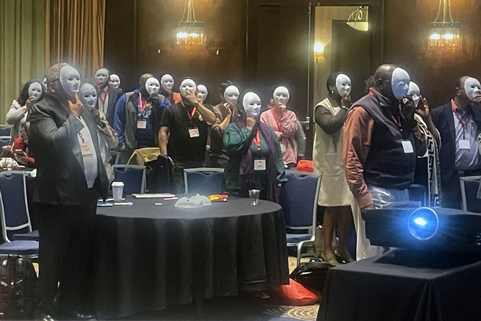 Attendees of the Nov. 14-16 Facing the Future conference in Atlanta pose with blank masks before decorating them as part of an exercise. The conference drew about 300 pastors serving in cross-cultural ministry to share their experiences and learn new ways to be effective. Photo courtesy of the United Methodist Commission on Religion and Race.