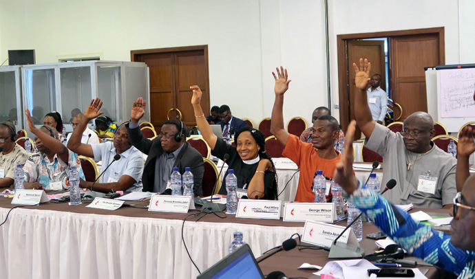 Leaders of theological institutions vote by a show of hands during the Africa Association of United Methodist Theological Institutions meeting held in Kinshasa, Congo. The association elected new leadership, including the Rev. Virginie Umba of Kamina Methodist University in Congo who will serve as president. Photo by Eveline Chikwanah, UM News. 