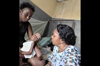Dr. Marie-Claire Manafundu (à droite) examine Crispin, âgé de 2 ans, au Centre Hospitalier Méthodiste de Mangobo à Kisangani, au Congo. Crispin fait partie des enfants malnutris de l'Est du Congo qui reçoivent des compléments alimentaires et des soins médicaux dans le cadre du programme de santé maternelle, néonatale et infantile de l'Église Méthodiste Unie. Photo avec l'aimable autorisation du département de la santé de l'Église Méthodiste Unie au Congo Est. 