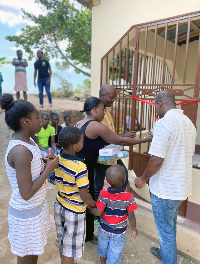 A Haitian family prepares to inspect their new home, built with the assistance of Zanmi Fondwa, a missions project headed by the Revs. David and Jamalyn Peigh Williamson, pastors in Indiana. Nearly 80 homes have been built so far. Photo courtesy of Zanmi Fondwa.