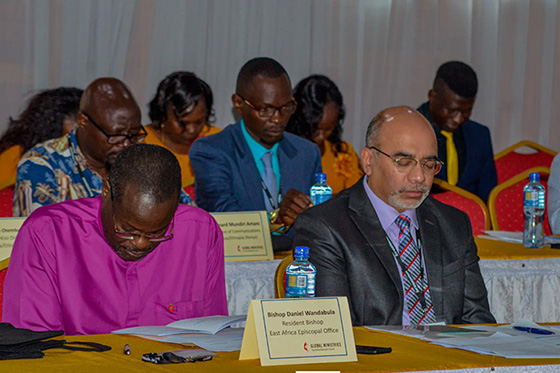 Bishop Daniel Wandabula (front left), episcopal leader of the East Africa Episcopal Area, and Roland Fernandes, top executive of the United Methodist Board of Global Ministries (front right), bow their heads in prayer during a mission consultation session in Nairobi, Kenya. Photo by David Nzuki Ndambuki, courtesy of Global Ministries.