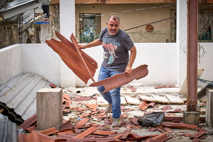 Moises Espinoza cleans up broken tiles on the roof of his home in Acapulco, Mexico, weeks after the devastating passage of Hurricane Otis. Espinoza is a businessman in Acapulco and a member of the Good Shepherd Methodist Church there. Photo by the Rev. Paul Jeffrey, UM News.