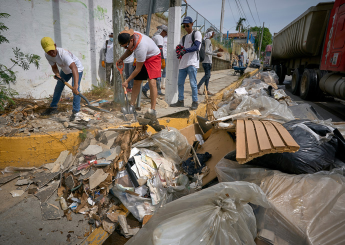 Residents of Acapulco, Mexico, work together cleaning their streets weeks after the devastating passage of Hurricane Otis, which struck the seaside city in October, 2023. The rapid intensification Hurricane Otis underwent in the hours before it slammed into southern Mexico is a symptom of the human-caused climate crisis, scientists say. Photo by the Rev. Paul Jeffrey, UM News.
