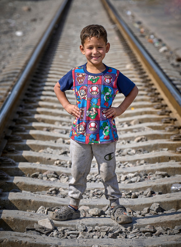 Sebastian, a 5-year-old Venezuelan boy, poses amid the railroad tracks in Apaxco, Mexico, where his family received assistance from a shelter run by the Methodist Church of Mexico, with support from the United Methodist Committee on Relief. Migrants often wait days in Apaxco for a freight train to stop so they can hop aboard and continue their journey northward. Photo by the Rev. Paul Jeffrey, UM News.