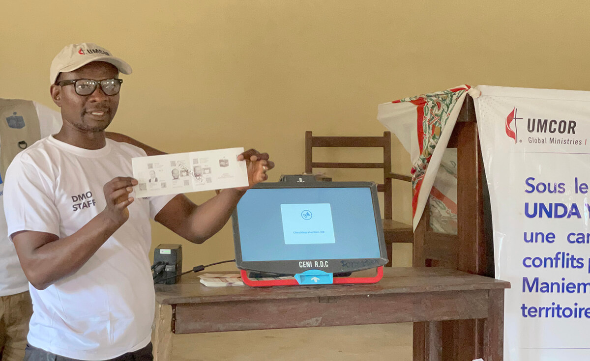Jean Tshomba demonstrates the procedure for voting during an educational program at Victor Wetchi United Methodist Church in the Kibombo District in Congo. Tshomba is coordinator of the local disaster management office. Financial support from the United Methodist Committee on Relief helped fund a program to prevent election-related violence. Photo by Chadrack Tambwe Londe, UM News.