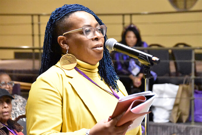 Chantay Love Mason, attending her first General Meeting as the new coordinator of the Philadelphia Black Methodists for Church Renewal caucus, asks a question about clergy mental health concerns during the March 6-9 meeting in Cincinnati. Photo by John Coleman, UM News.
